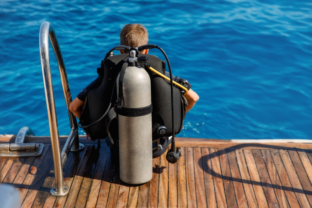 A,Teenage,Boy,In,A,Diving,Suit,With,An,Oxygen